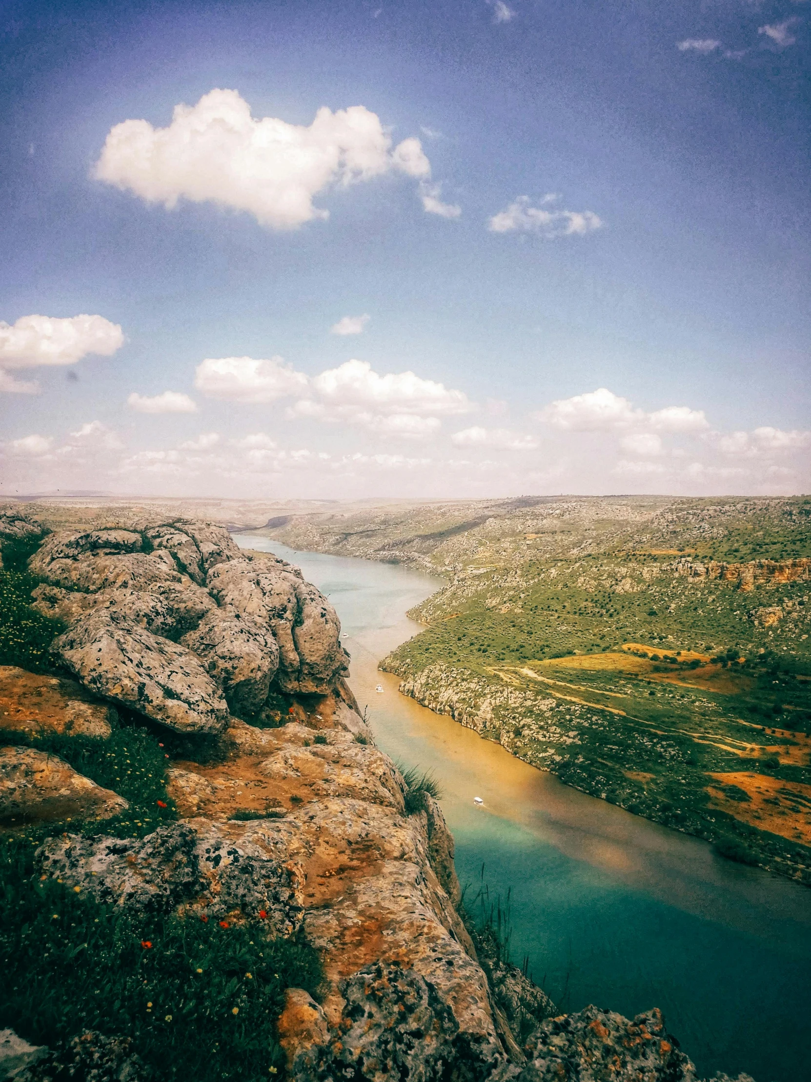 a view of the water from an overcast cliff