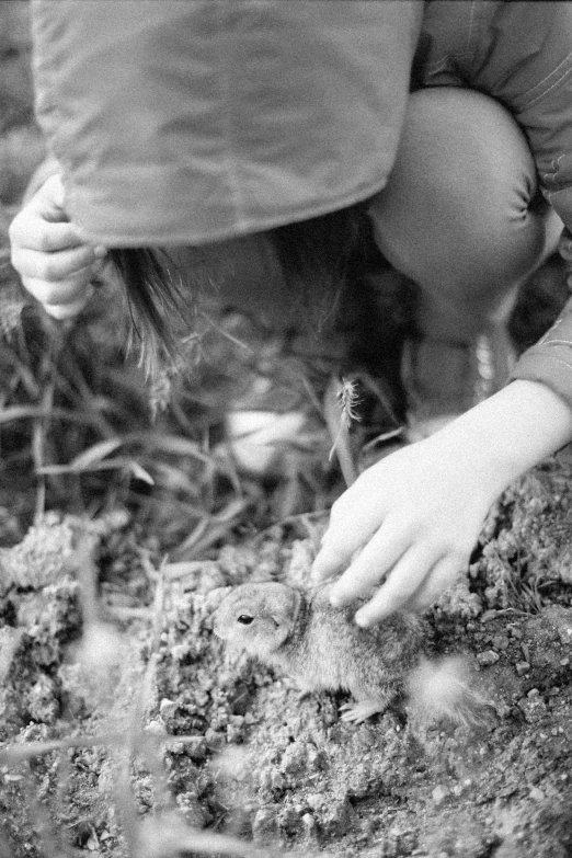 a little girl that is reaching for soing