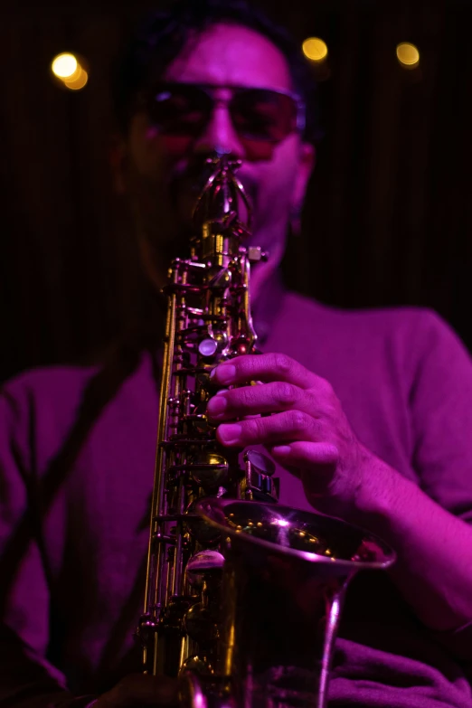 a man playing the saxophone on stage in a concert