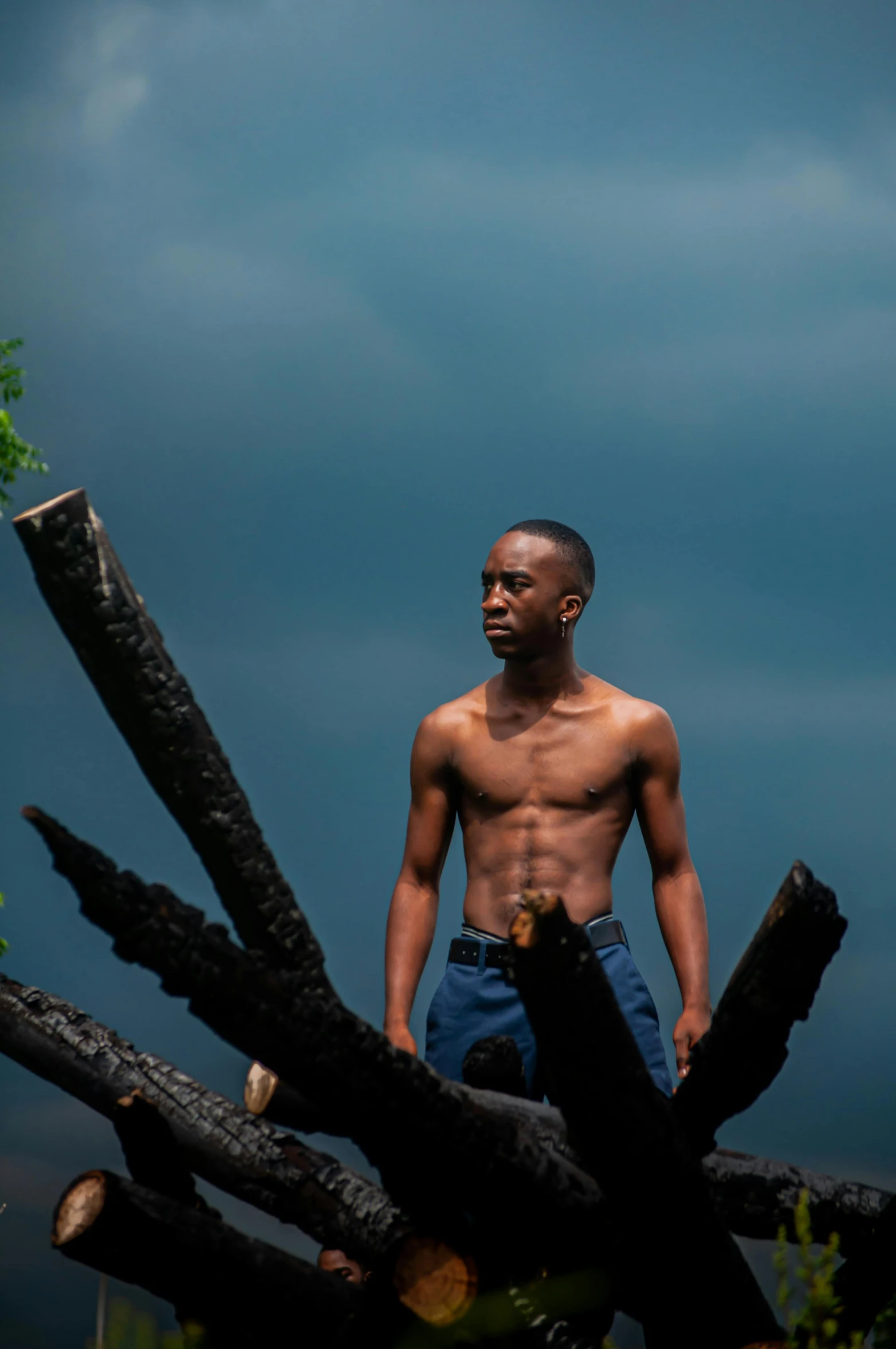 a man standing in front of large pieces of wood