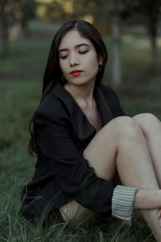 a beautiful asian woman with a dark jacket and red lipstick on her lips