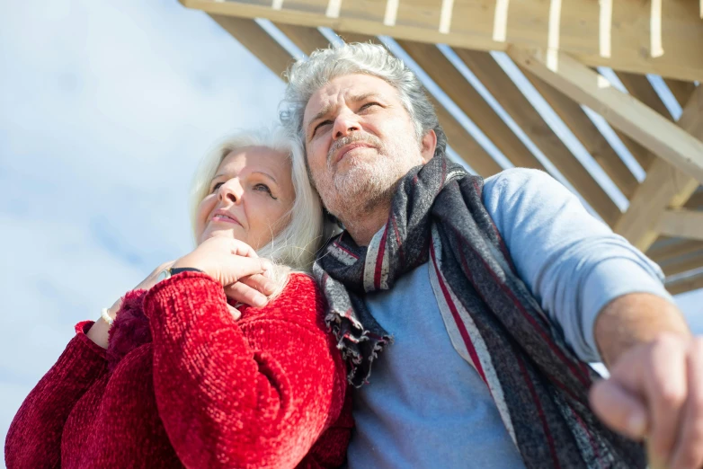 the couple is posing for the camera in the park