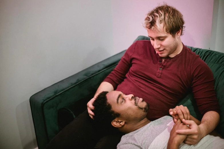 a couple of people laying on top of a bed