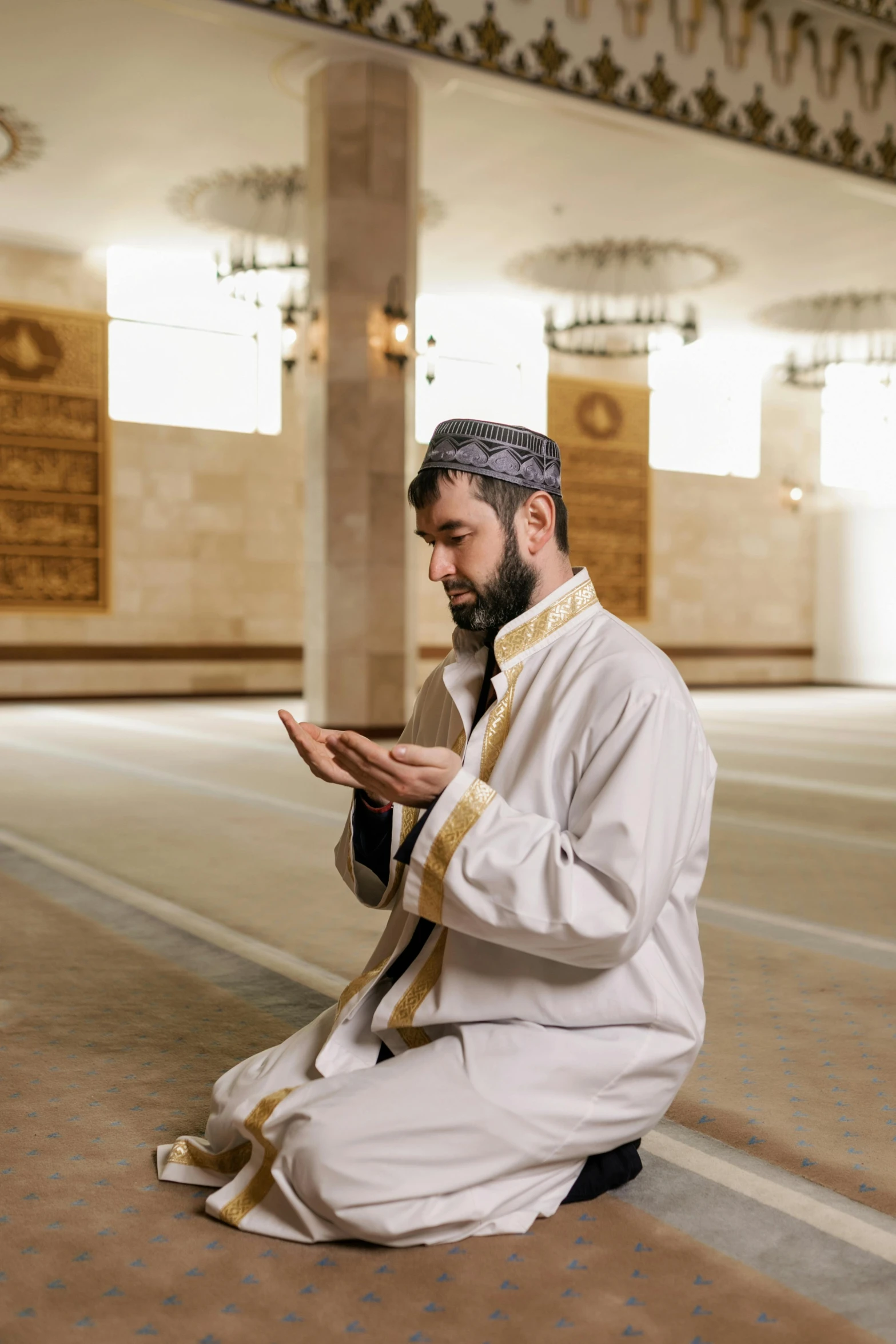 a man is sitting and looking at his cellphone