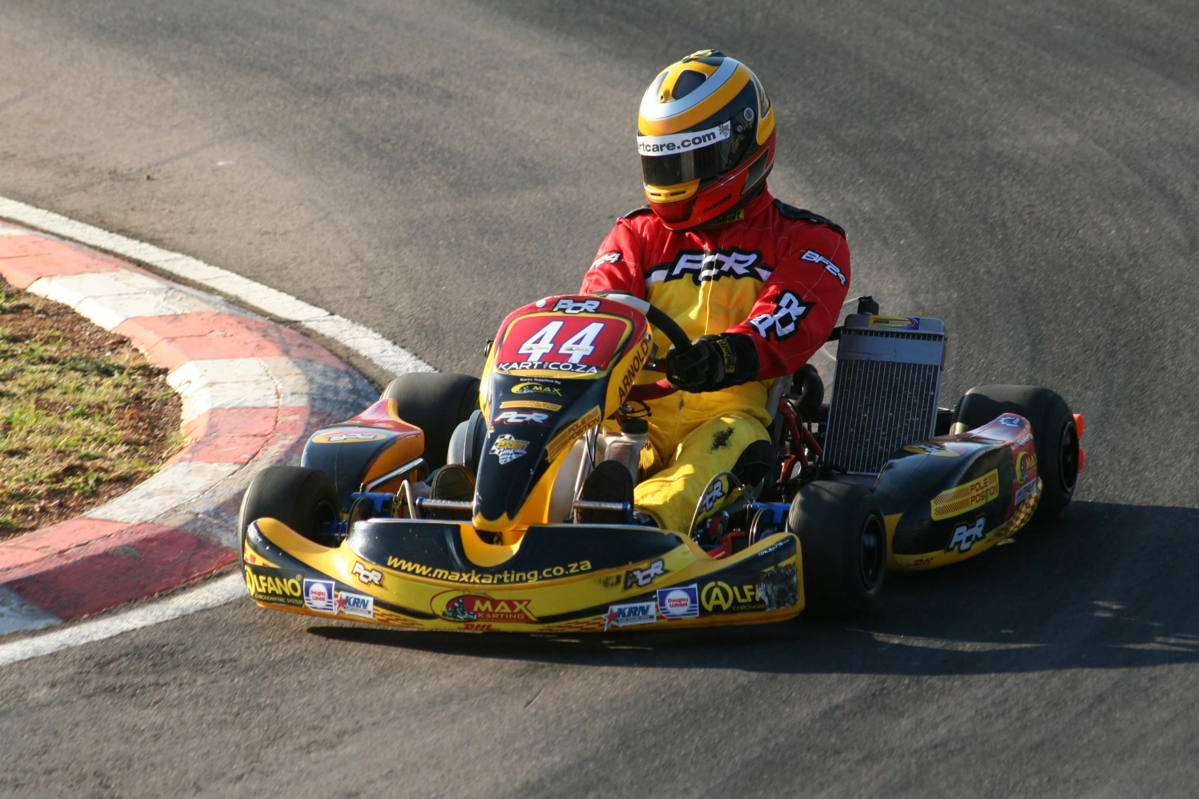 a man driving a go kart down a winding track