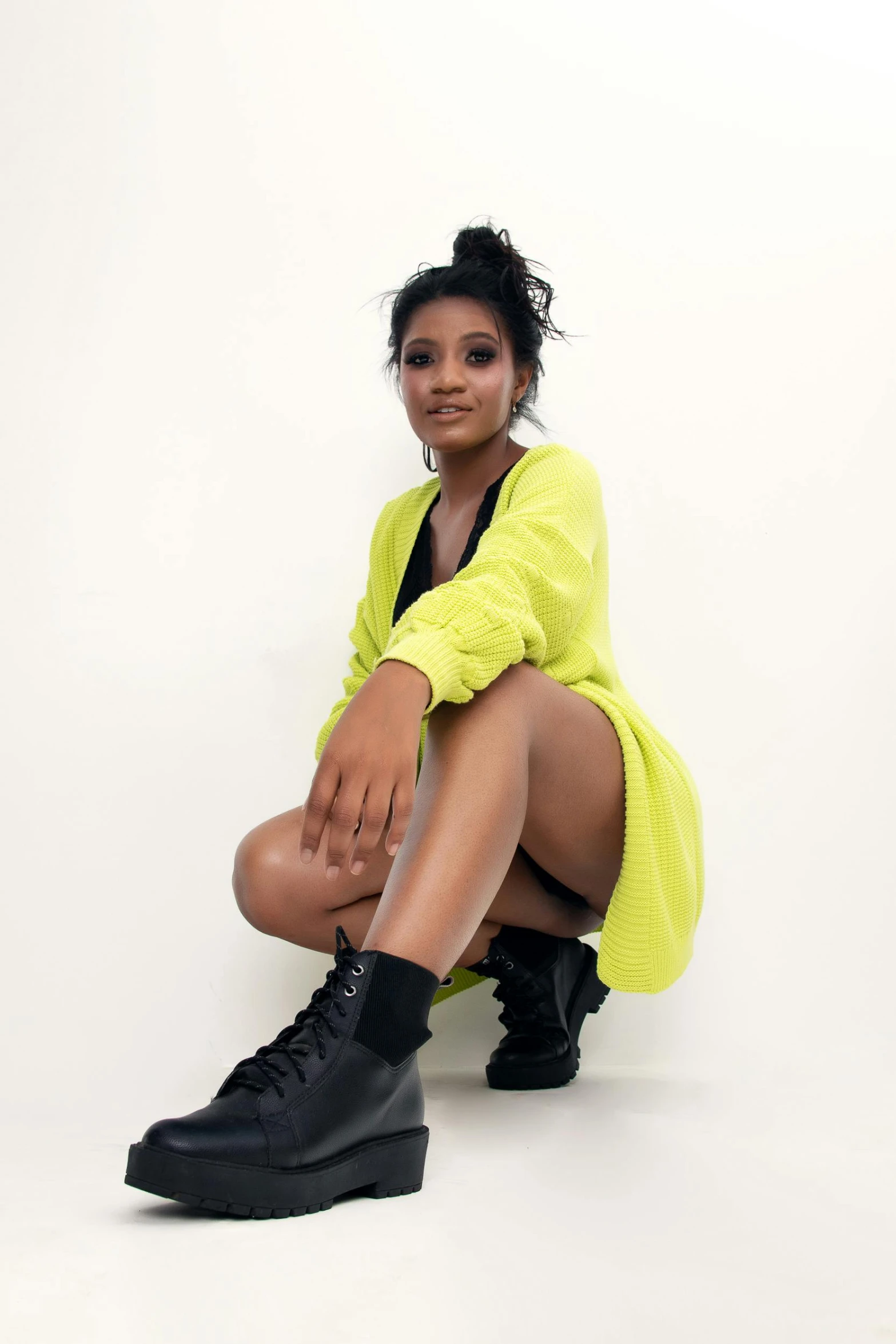 young indian woman with booties posing for the camera