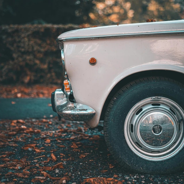 there is an old, white truck parked on the street