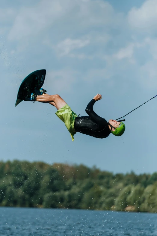 a man kite surfing on the ocean, on a sunny day