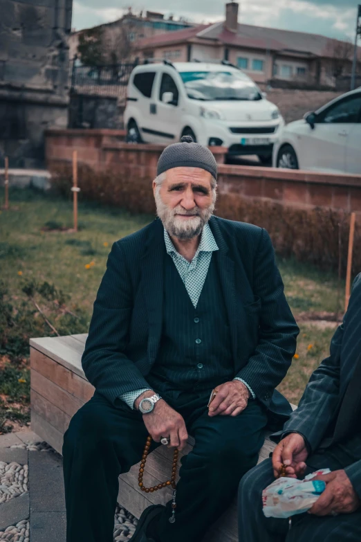 two old men sit next to each other