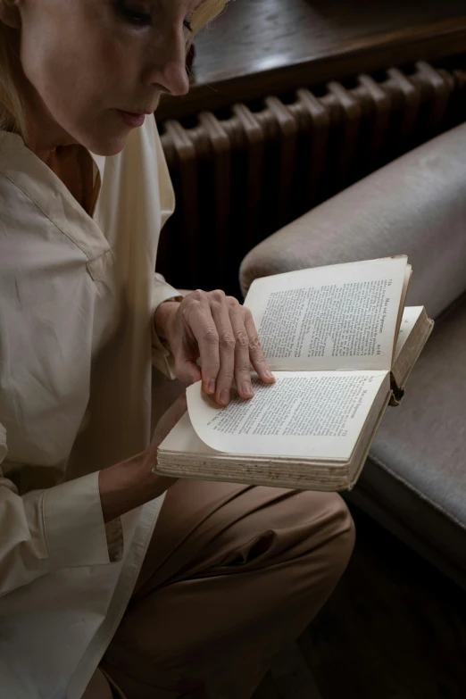 the woman is reading a book by herself