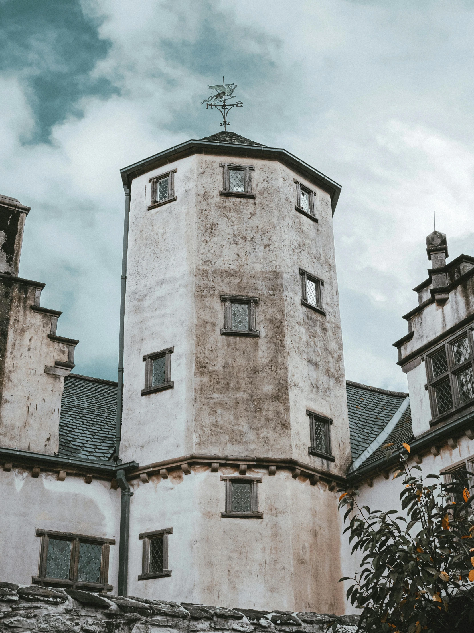 an old brick building with two spires on top