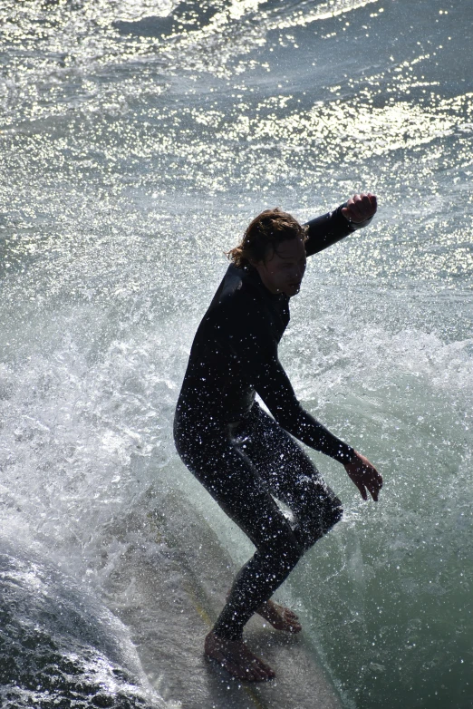 man riding the waves on his surfboard in the ocean