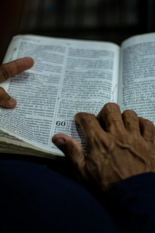 a person holds the page of an old book