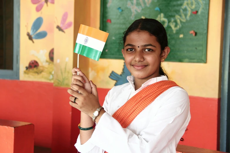 a girl holding a small flag and smiling