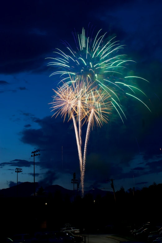 colorful fireworks are in the night sky over parking lots