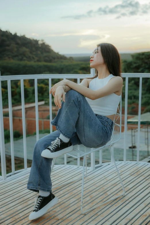 a girl sitting in a chair on the ground