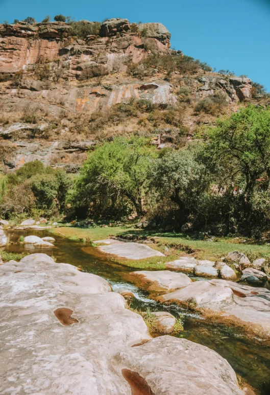 a rocky stream that runs through a mountainous area