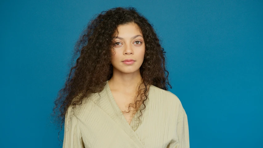 a woman with large hair is posing for the camera