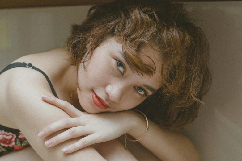 a young woman with curly red hair, wearing a black and white 