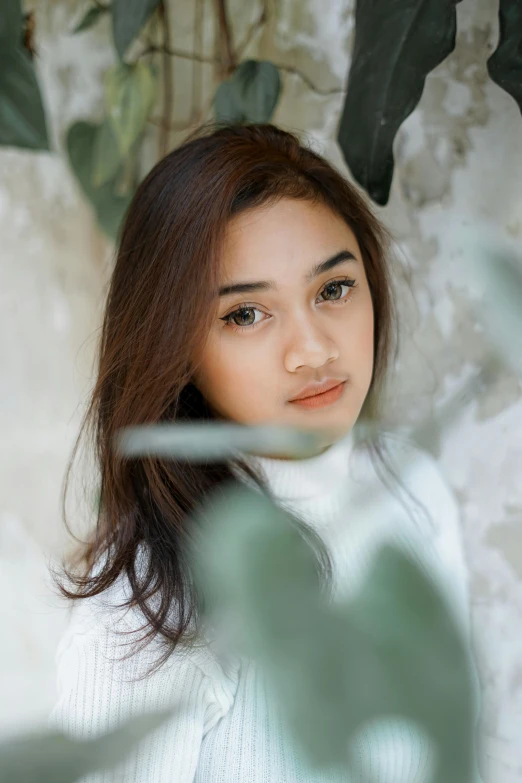 a girl in white sweater looking straight ahead