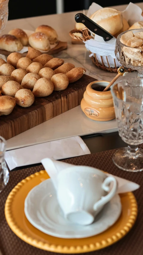 breads and pastries are displayed on a platter on a table