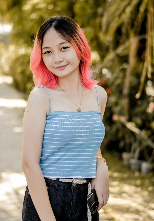 a woman with pink hair poses for a picture