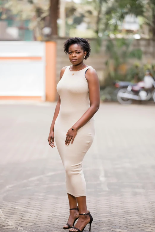 a beautiful young lady wearing tight, white dress and heels