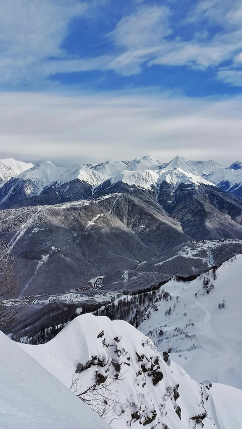 a person wearing skis on the top of a mountain