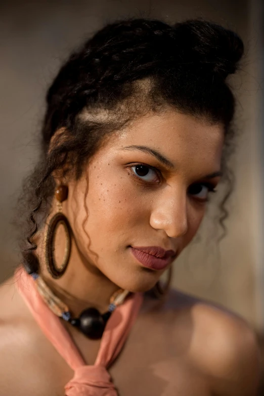 a young woman with ids and a shirt with a necklace and earrings