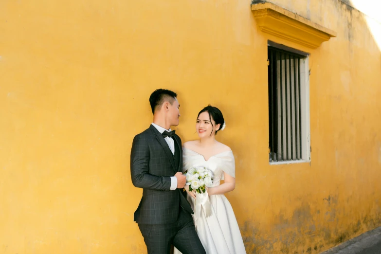 a man and woman wearing formal clothes standing together