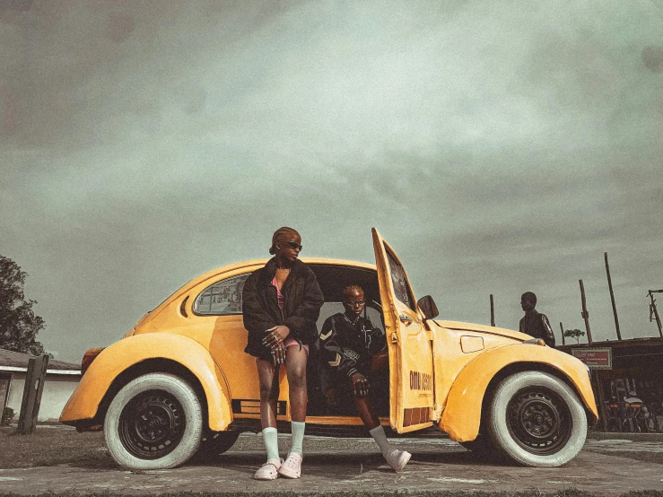 a woman is standing in the cab of an old car