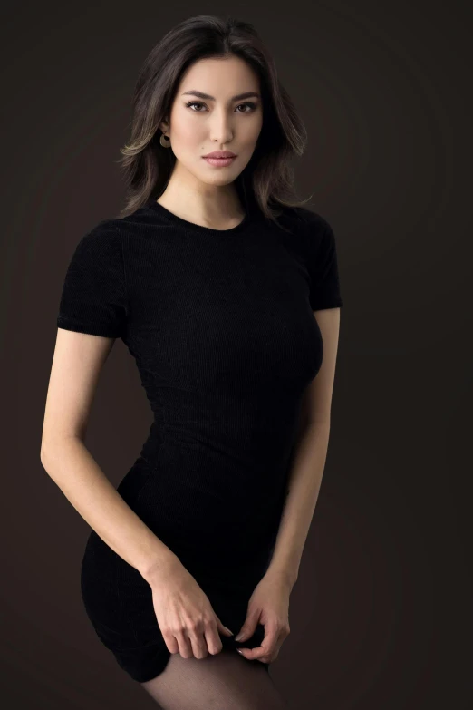 a young woman poses in black clothes