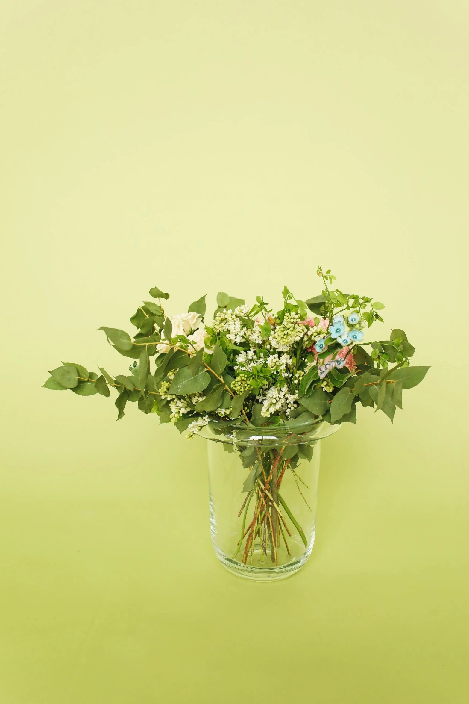 a jar filled with lots of different kinds of flowers