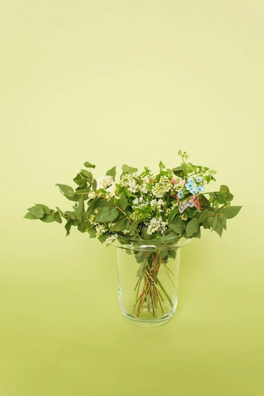 a jar filled with lots of different kinds of flowers