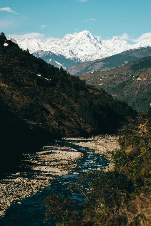 there is a train going down the tracks near the mountains