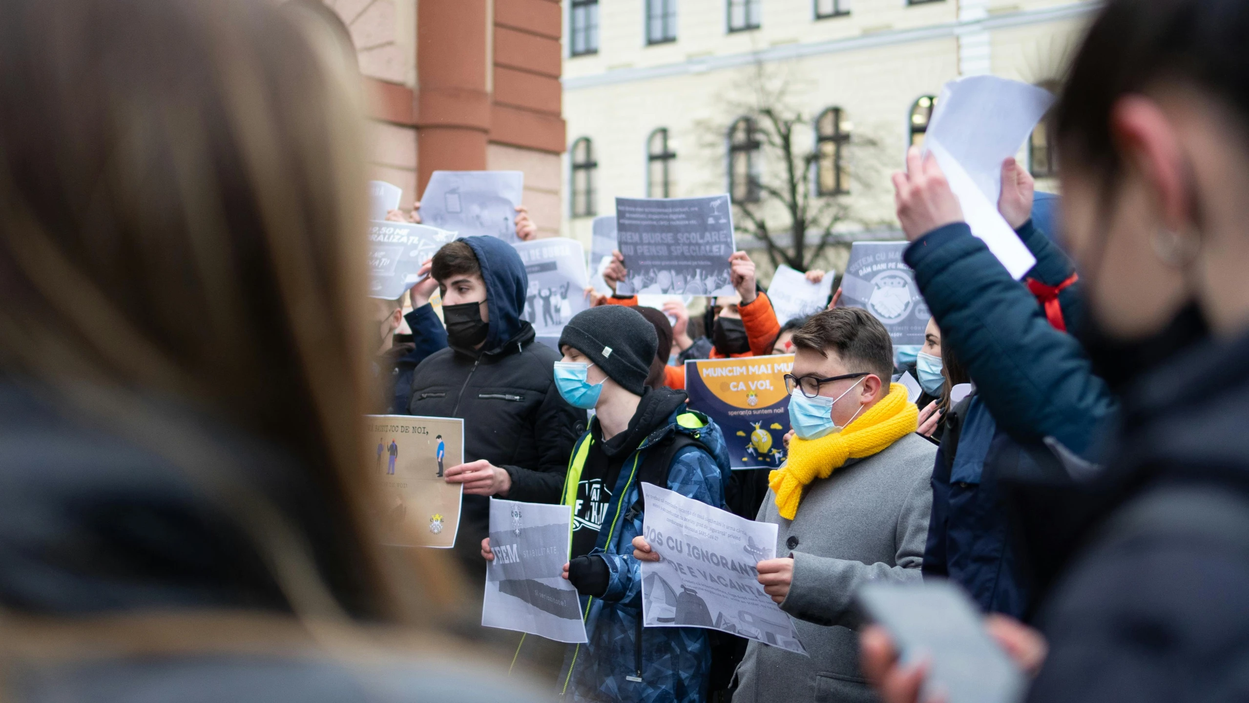 people gathered at protest with masks on