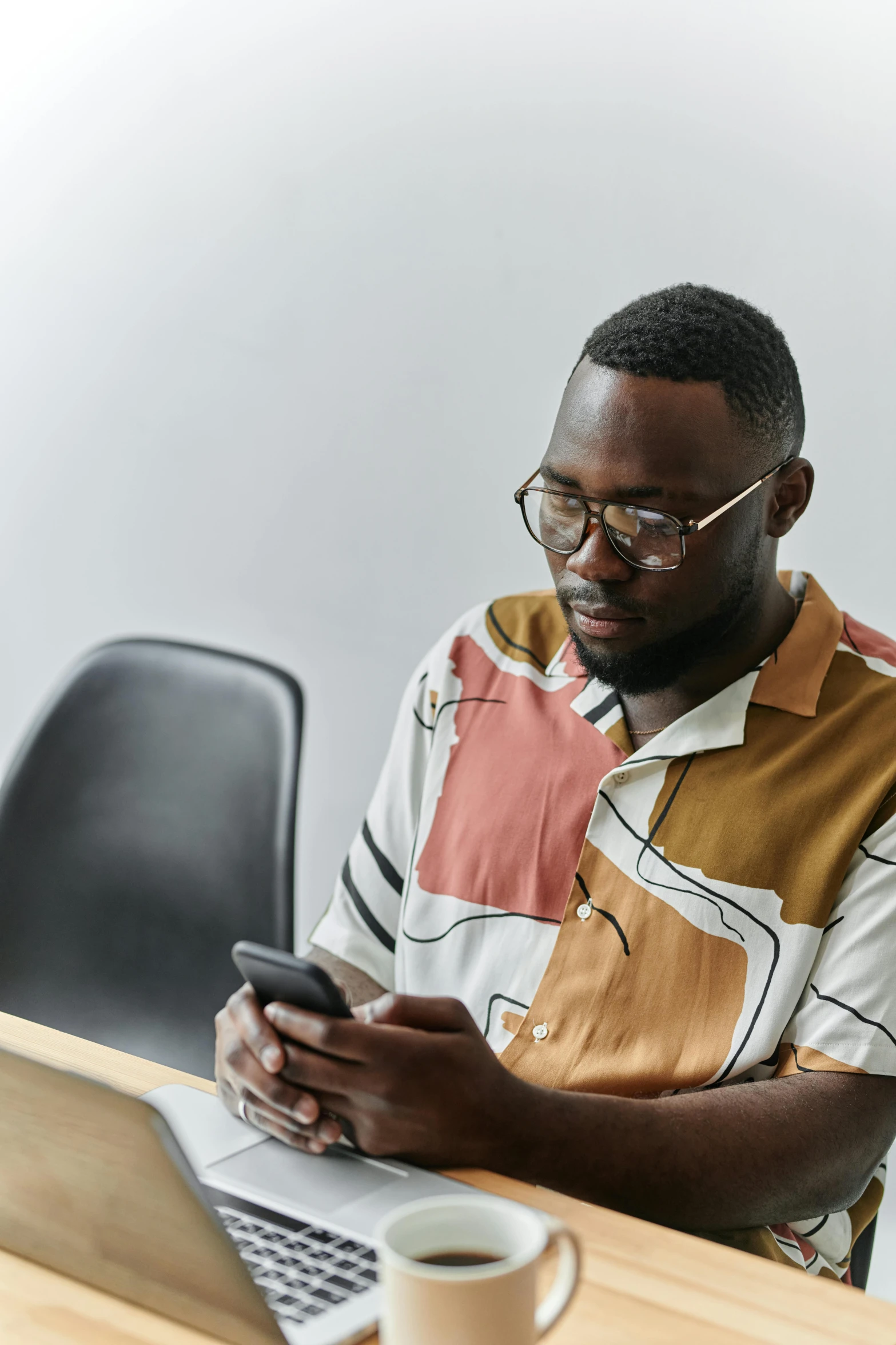 a man using a laptop computer sitting on a desk