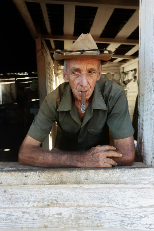 a man in uniform sits on the steps of his house