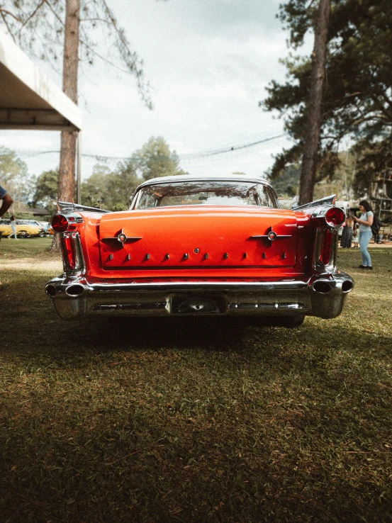 an old classic car in a grassy field