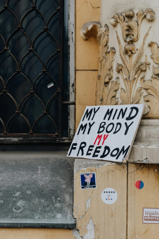 a sign with writing on it that says, my mind my body my freedom