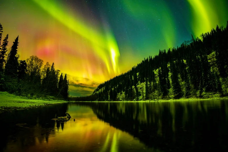 the colorful lights of the aurora over a lake at night