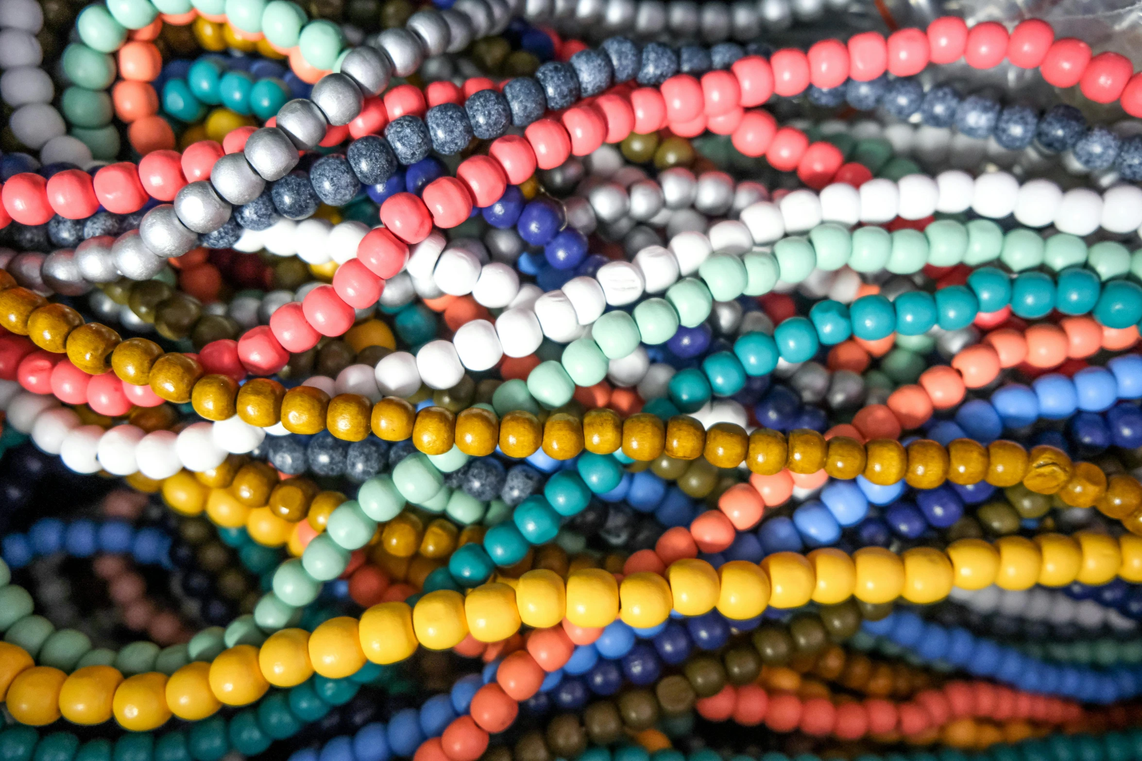 there are many beads on a colorful surface