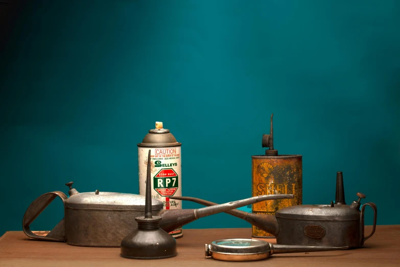 an old watering can, coffee pot, and metal kettles