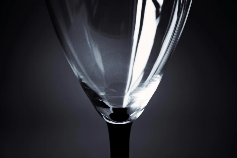 a wine glass sitting upright with a very blurry background