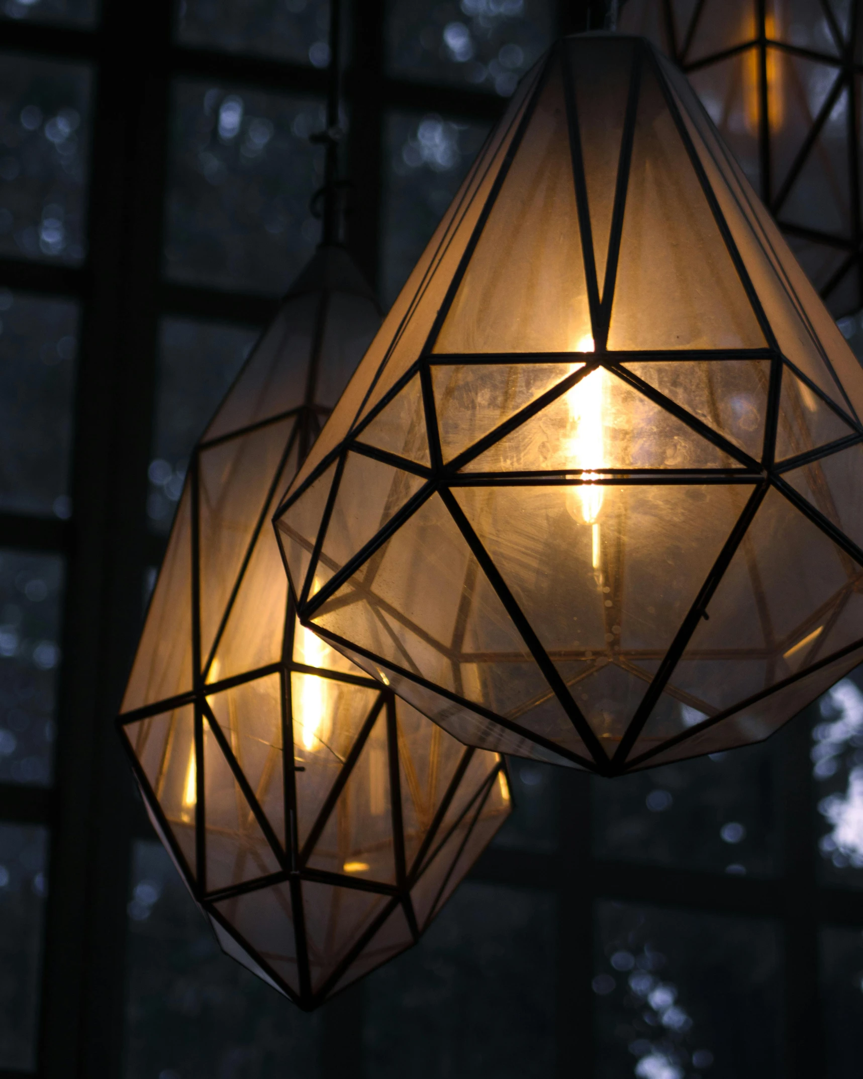 three lights that are sitting inside of a room