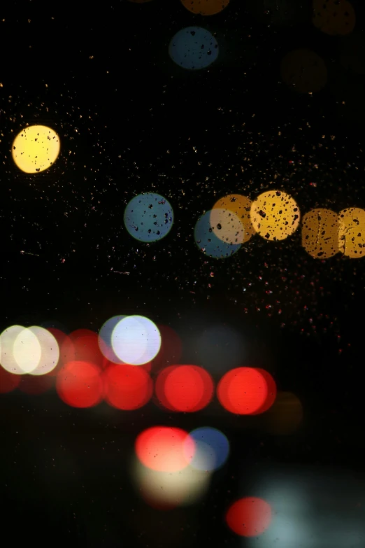 a bunch of car lights at night and rain