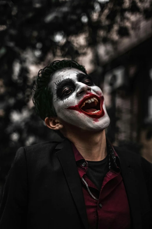 a man with his face painted like the joker