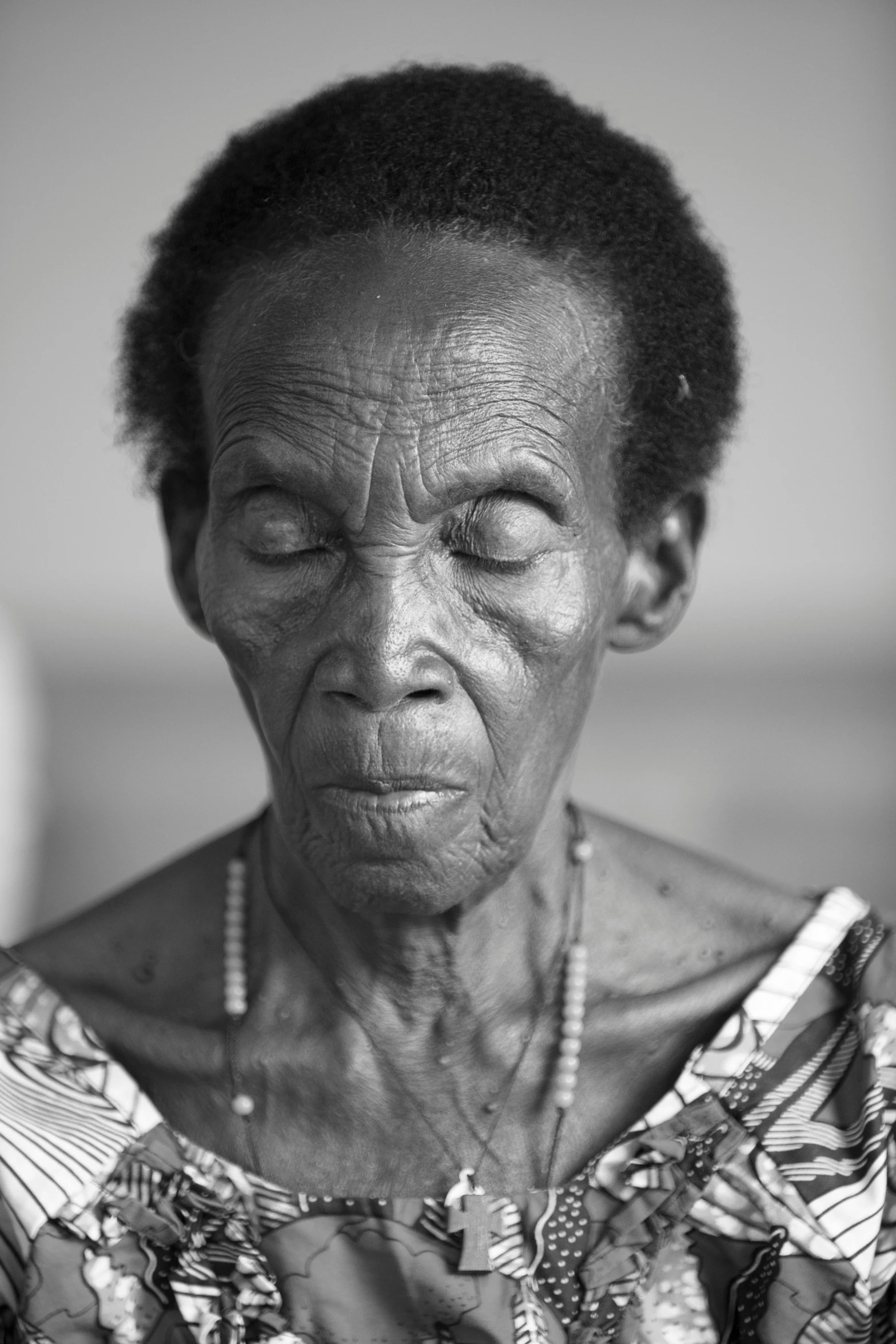 a black woman looking up while holding soing