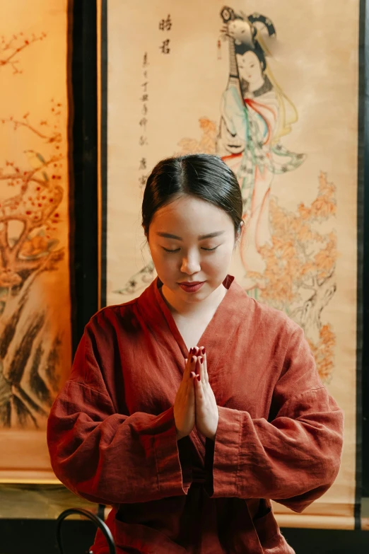 a woman is wearing a red kimono
