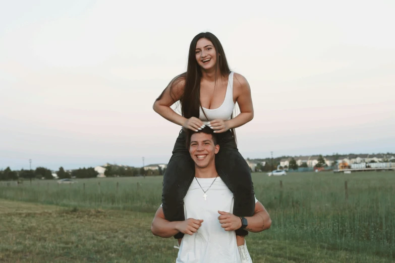 a man riding on the shoulders of his girl